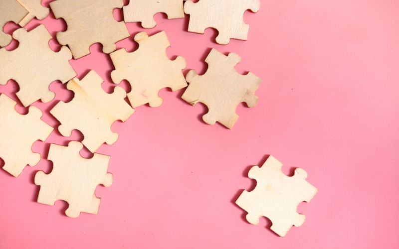Pieces of a wooden jigsaw signifying putting one's life back together